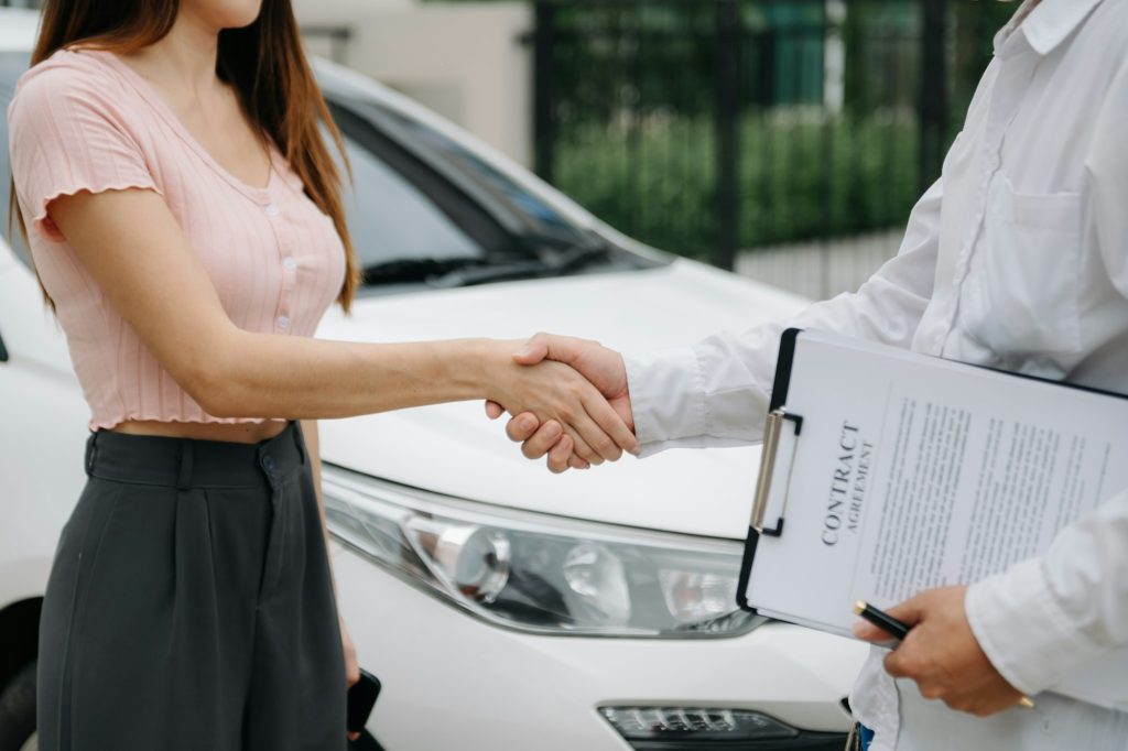 Automotive business, car sale or rental concept Customer with car dealer agent making deal