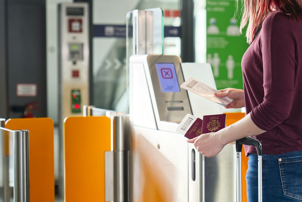 Passenger Safely Checking Passport at Automated Gate at the Airport - Traveling Documents